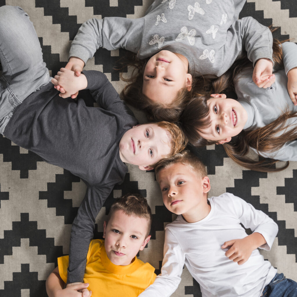 kids posing together laying floor